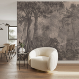 A large-scale black and white forest landscape wallpaper mural is displayed on a wall in a modern dining room setting, featuring a white textured armchair in the foreground and a dining table on the left.