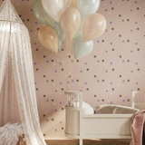 Children's room with polka dot wallpaper, crib, and balloons.